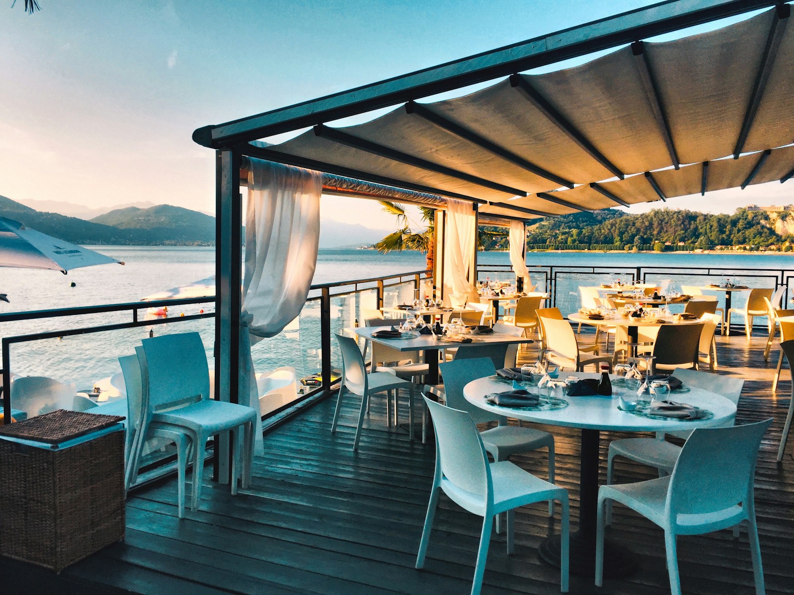Luxury outdoor restaurant terrace at night with candles and ocean view